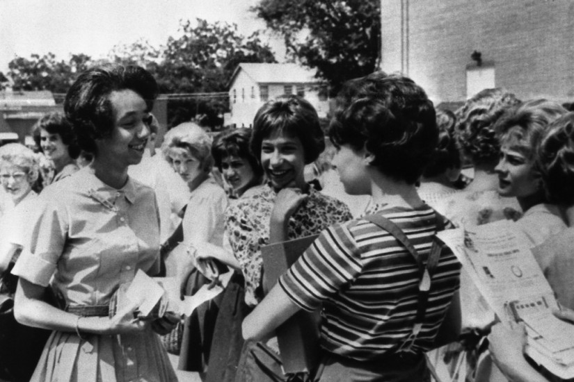 Photo of Ruby Bridges, one of the first black teens to enter a recently desegregated white school in South Carolina in 1963. The white students in the background are staring at her with looks of hatred and contempt.